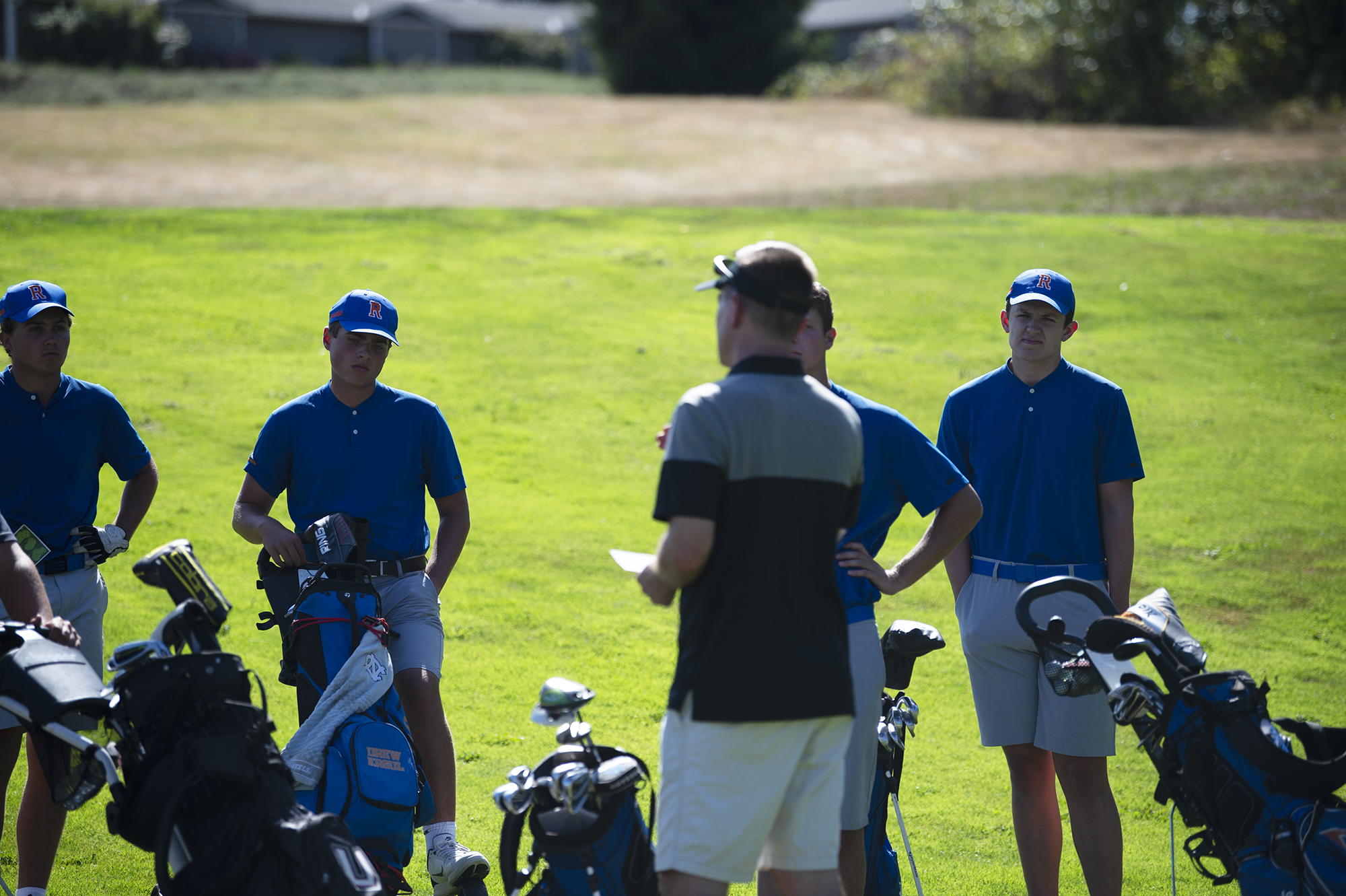 Ridgefield golfers look on as Union coach Gary Mills gives instructions before the high school boys golf match between Ridgefield and Union at Camas Meadows Golf Course on Monday, Aug. 29, 2022.