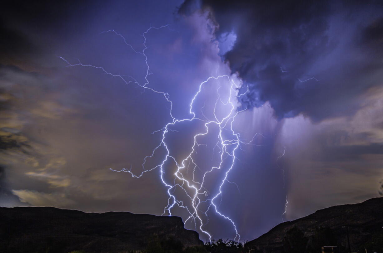 In this photo provided by Dakota Snider, a thunderstorm is seen from Highway 159 over Las Vegas on Thursday, Aug. 11, 2022. A summer monsoon thunderstorm season unseen in Las Vegas in the last 10 years brought lightning and heavy rain to some areas late Thursday, and ceiling leaks that soaked playing cards and gambling at some Strip casinos. No injuries were reported, and damage estimates were not immediately provided as Friday dawned sunny and clear.
