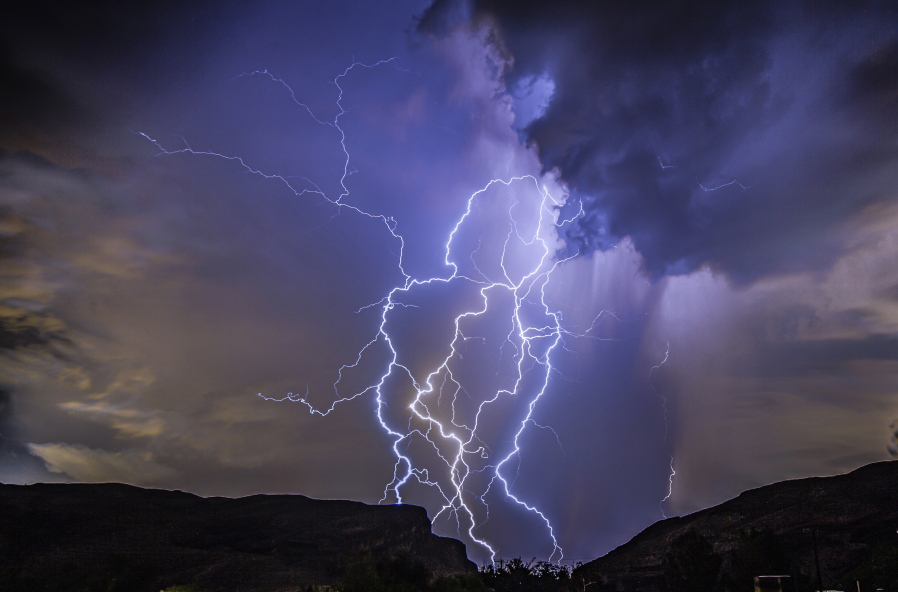 In this photo provided by Dakota Snider, a thunderstorm is seen from Highway 159 over Las Vegas on Thursday, Aug. 11, 2022. A summer monsoon thunderstorm season unseen in Las Vegas in the last 10 years brought lightning and heavy rain to some areas late Thursday, and ceiling leaks that soaked playing cards and gambling at some Strip casinos. No injuries were reported, and damage estimates were not immediately provided as Friday dawned sunny and clear.