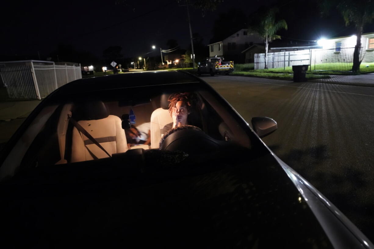 Jada Riley sits in her car at night with her son Jayden Harris, 6, as she contemplates where she might spend the night, having had to move out of her apartment a few days before, Thursday, July 28, 2022, in New Orleans. "I've slept outside for a whole year before. It's very depressing, I'm not going to lie," said Riley, who often doesn't have enough money to buy gas or afford food every day.