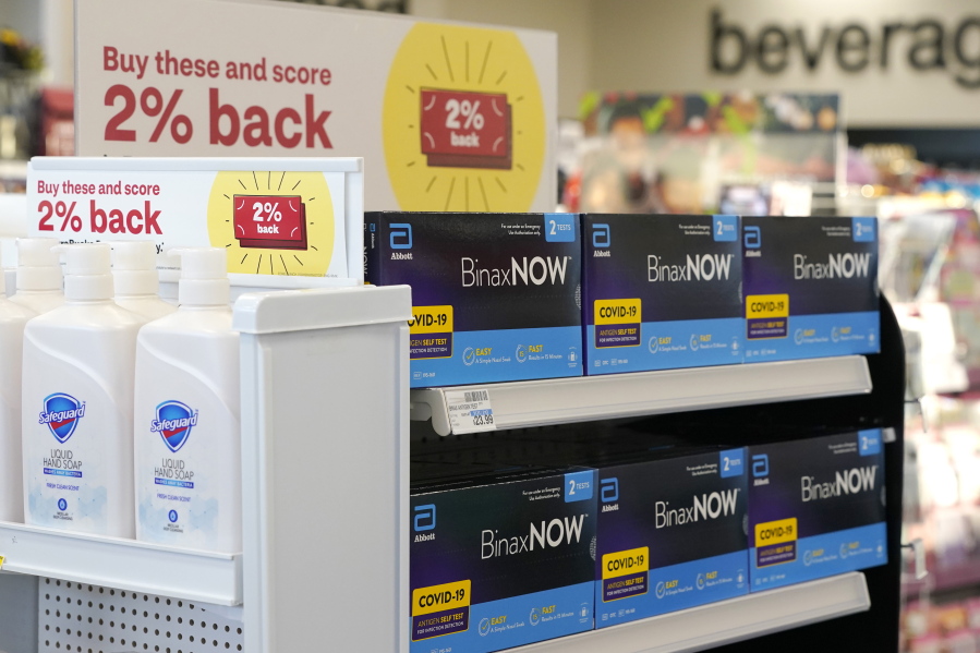 FILE - Boxes of BinaxNow home COVID-19 tests made by Abbott displayed for sale next to liquid hand soap at a CVS store in Lakewood, Wash., Monday, Nov. 15, 2021. People screening themselves at home for COVID-19 may need to use three rapid tests to accurately detect the virus, according to new U.S. recommendations released Thursday, Aug. 11, 2022, that call for a longer testing period. (AP Photo/Ted S.
