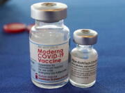 FILE - This Sept. 21, 2021 file photo shows vials of the Pfizer and Moderna COVID-19 vaccines in Jackson, Miss. Moderna is suing its main competitors Pfizer and the German drugmaker BioNTech, accusing the rivals of copying Moderna's technology in order to make their own vaccine. Moderna said Friday, Aug. 26, 2022, that Pfizer and BioNTech's vaccine Comirnaty infringes on patents Moderna filed several years ago protecting the technology behind its preventive shot, Spikevax.  (AP Photo/Rogelio V.