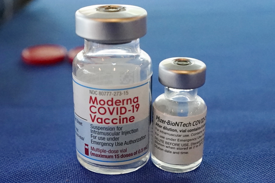 FILE - This Sept. 21, 2021 file photo shows vials of the Pfizer and Moderna COVID-19 vaccines in Jackson, Miss. Moderna is suing its main competitors Pfizer and the German drugmaker BioNTech, accusing the rivals of copying Moderna's technology in order to make their own vaccine. Moderna said Friday, Aug. 26, 2022, that Pfizer and BioNTech's vaccine Comirnaty infringes on patents Moderna filed several years ago protecting the technology behind its preventive shot, Spikevax.  (AP Photo/Rogelio V.