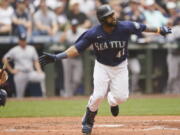 Seattle Mariners' Carlos Santana tosses his bat after hitting a two-run home run against the New York Yankees during the seventh inning of a baseball game, Wednesday, Aug. 10, 2022, in Seattle. (AP Photo/Ted S.