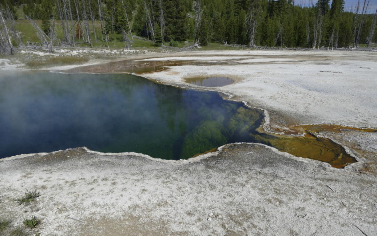 In this photo provided by the National Park Service is the Abyss Pool hot spring in the southern part of Yellowstone National Park, Wyo., in June 2015. Park officials say part of a foot, in a shoe, found floating in the hot spring on Tuesday, Aug. 16, 2022, is related to a July 31, 2022 death. No foul play is suspected, but the investigation continues.