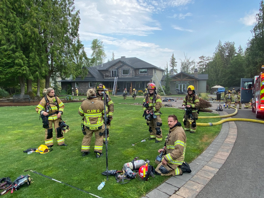 Firefighters who extinguished an attic fire that displaced two people Monday morning at a 5,000-square-foot house in Ridgefield.
