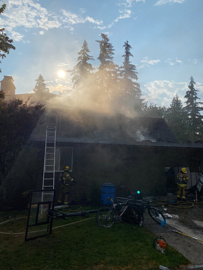 Smoke coming from a 5,000-square-foot house in Ridgefield where an attic fire displaced two people Monday morning. No one was home when firefighters arrived.
