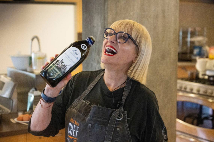 Chef and author Maria Loi of New York holds a bottle of olive oil during a class for "olive-curious youth" Sept. 2 at the University of California Davis Olive Center.