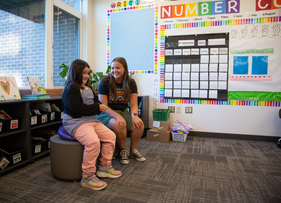 Kindergartener Claire Hagan, left, tries out a "wiggle seat" while getting a tour of her new classroom from teacher Kalli Kritsonis at Sumas Elementary on Aug. 29.
