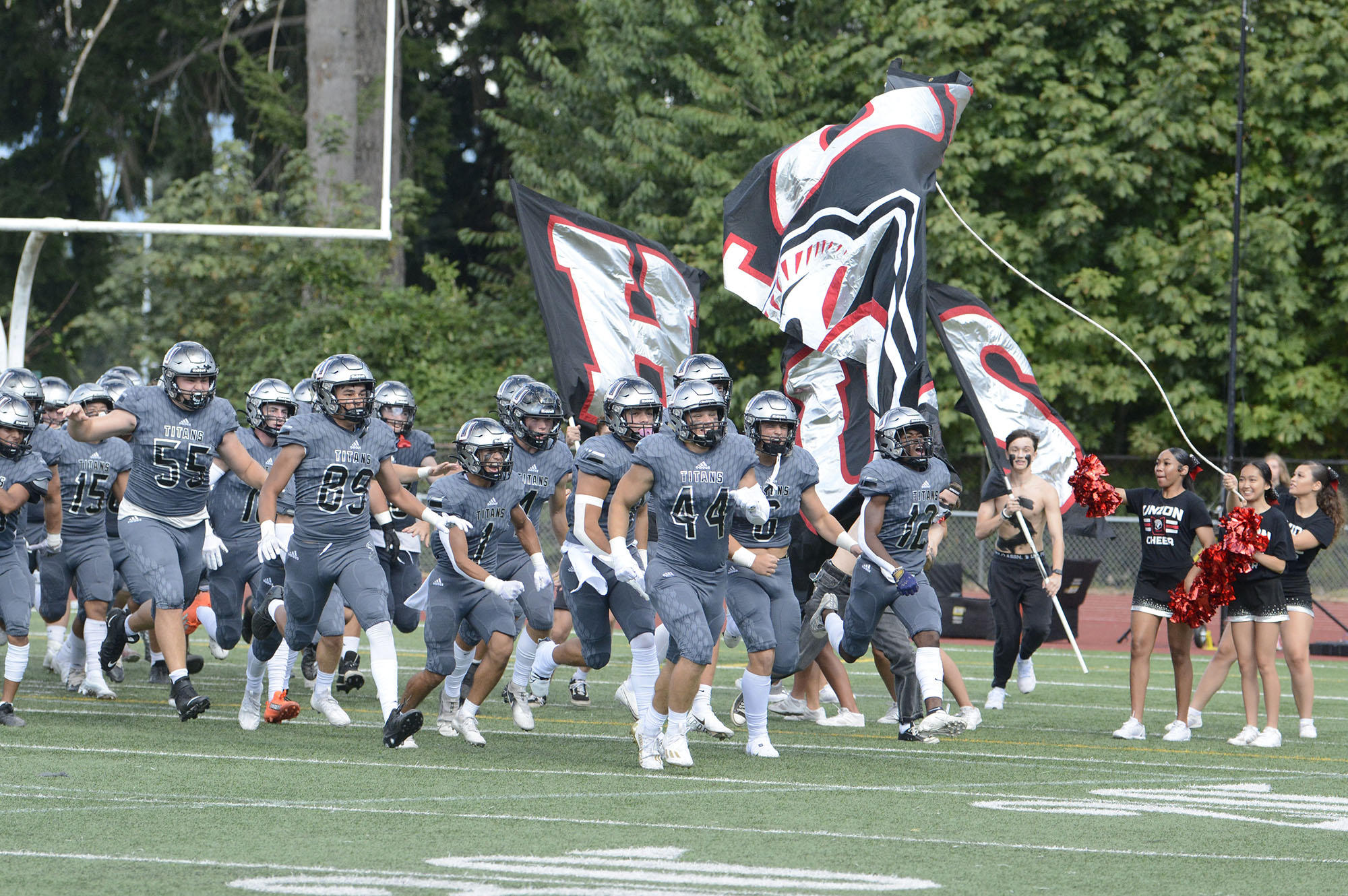 Union players run on to the field prior to the start of Saturday’s season-opening game against Eastlake at McKenzie Stadium in Vancouver (Will Denner/The Columbian)