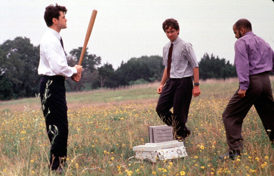 Ron Livingston, David Herman and Ajay Naidu take revenge on their dreaded nemesis, the office fax machine, in a scene from Twentieth Century Fox's "Office Space." (Hulton Archive/Getty Images/TNS)
