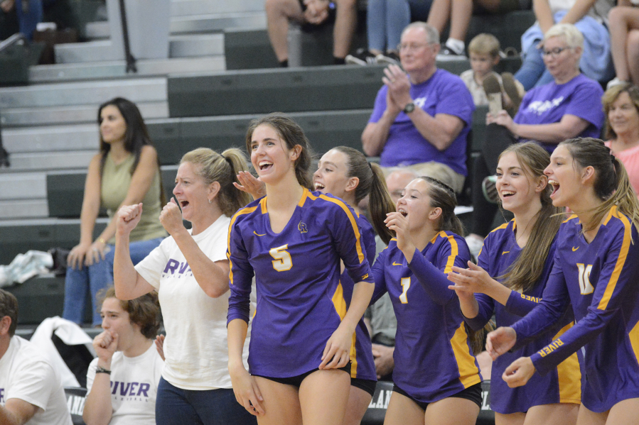 Lauren Dreves (5) and the rest of the Columbia River bench celebrate a point during the Rapids? season-opening win over Woodland on Tuesday, Sept. 6, 2022.