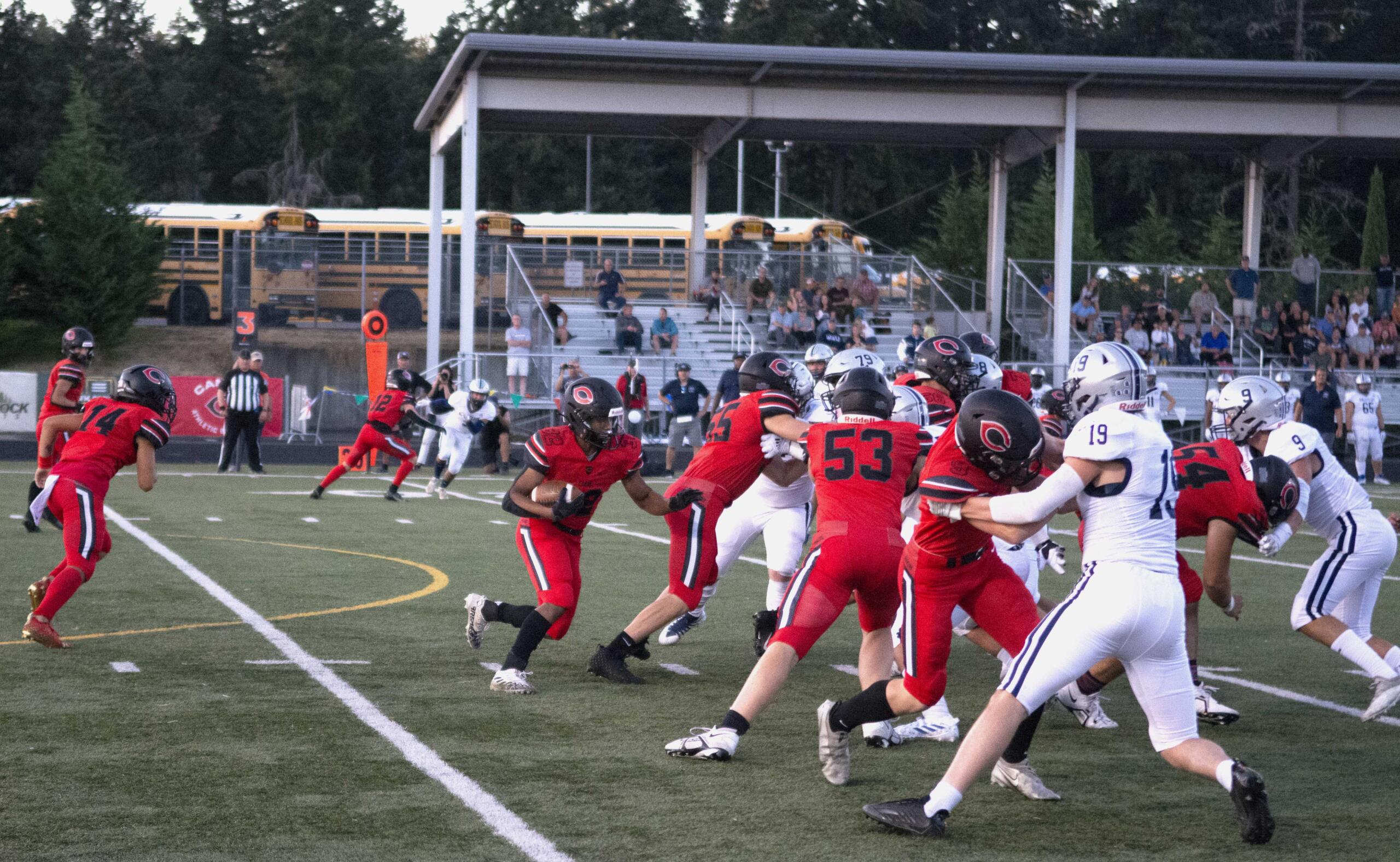 Camas running back Titan Brody (32) looks for an opening after receiving a handoff from quarterback Taylor Ioane (14) against Glacier Peak on Friday at Doc Harris Stadium in Camas (Will Denner/The Columbian)