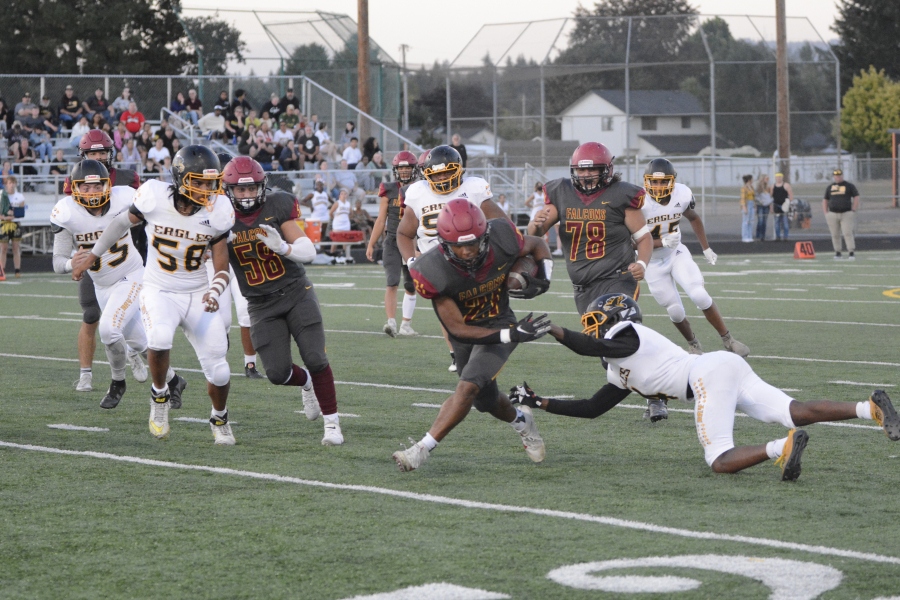 Prairie running back Alex Ford (21) avoids a Hudson's Bay defender during a 25-yard touchdown run in the first quarter of a 56-0 win on Friday, Sept. 9, 2022 at District Stadium in Battle Ground.