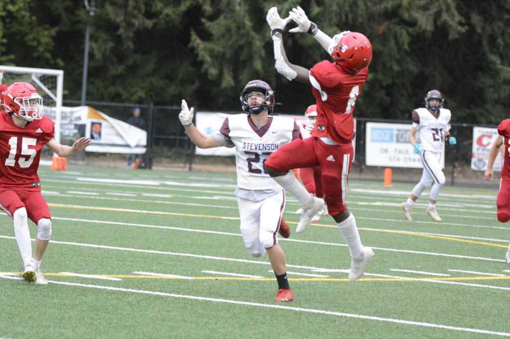 Fort Vancouver's Anton Hill leaps for an interception over Stevenson receiver Joseph Jenkins during the first quarter of a Trico League game on Friday, Sept.