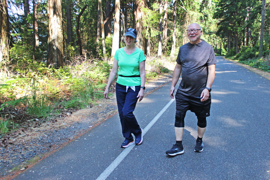 Tacoma residents Barbara Clark and Al Choy get their steps in along the outer loop of Five Mile Drive in Tacoma's Point Defiance Park.