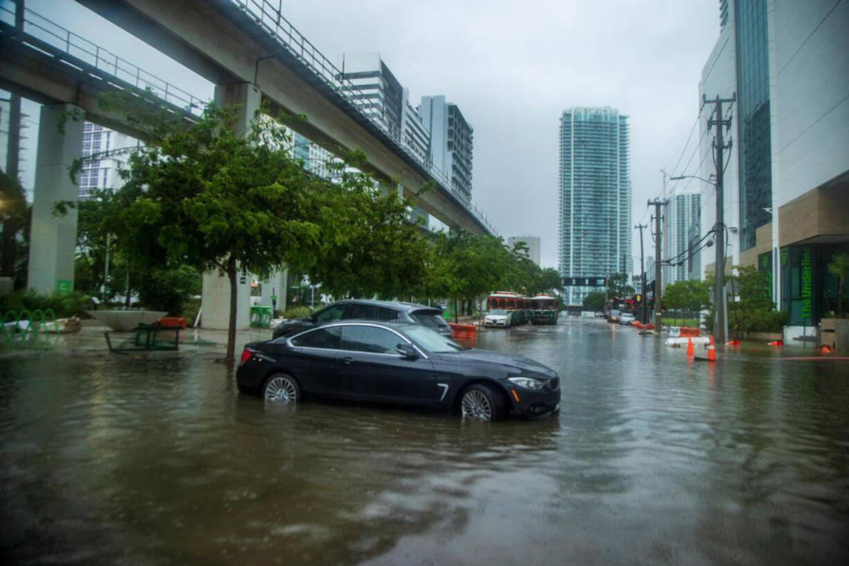 Massive rainfall from the hurricane season's first disturbance caused floods, stranding cars and soaking businesses in the Brickell area near downtown Miami on June 4.