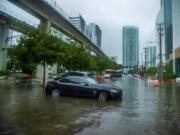 Massive rainfall from the hurricane season's first disturbance caused floods, stranding cars and soaking businesses in the Brickell area near downtown Miami on June 4.