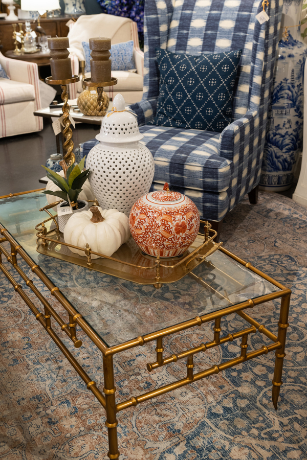 A white pumpkin is paired with neutral accessories for a beautiful traditional coffee table centerpiece.