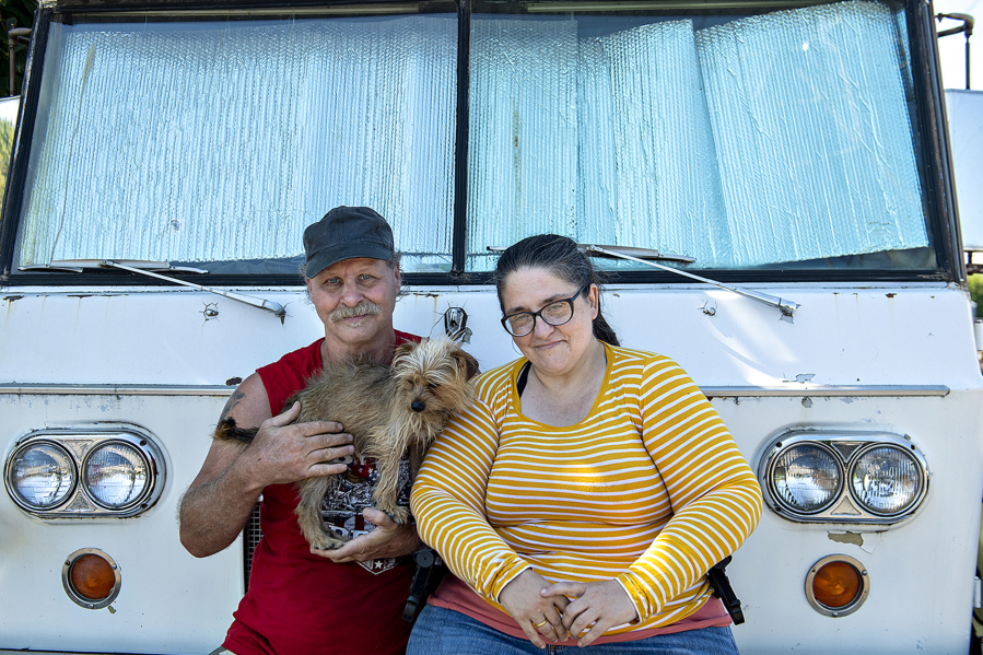 Tom Piercey takes a break with the family dog, Lulu, and his long-term partner, R.J., at the Evergreen Safe Parking Zone.  The couple have been living out of their van for nearly three years.