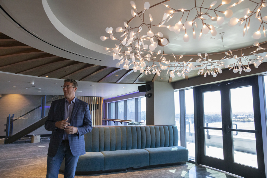 Above, Chad Mackay, CEO of El Gaucho, shares details about the multiple restaurants while standing inside the Witness Tree bar at Kirkland Tower and Hotel Indigo.
