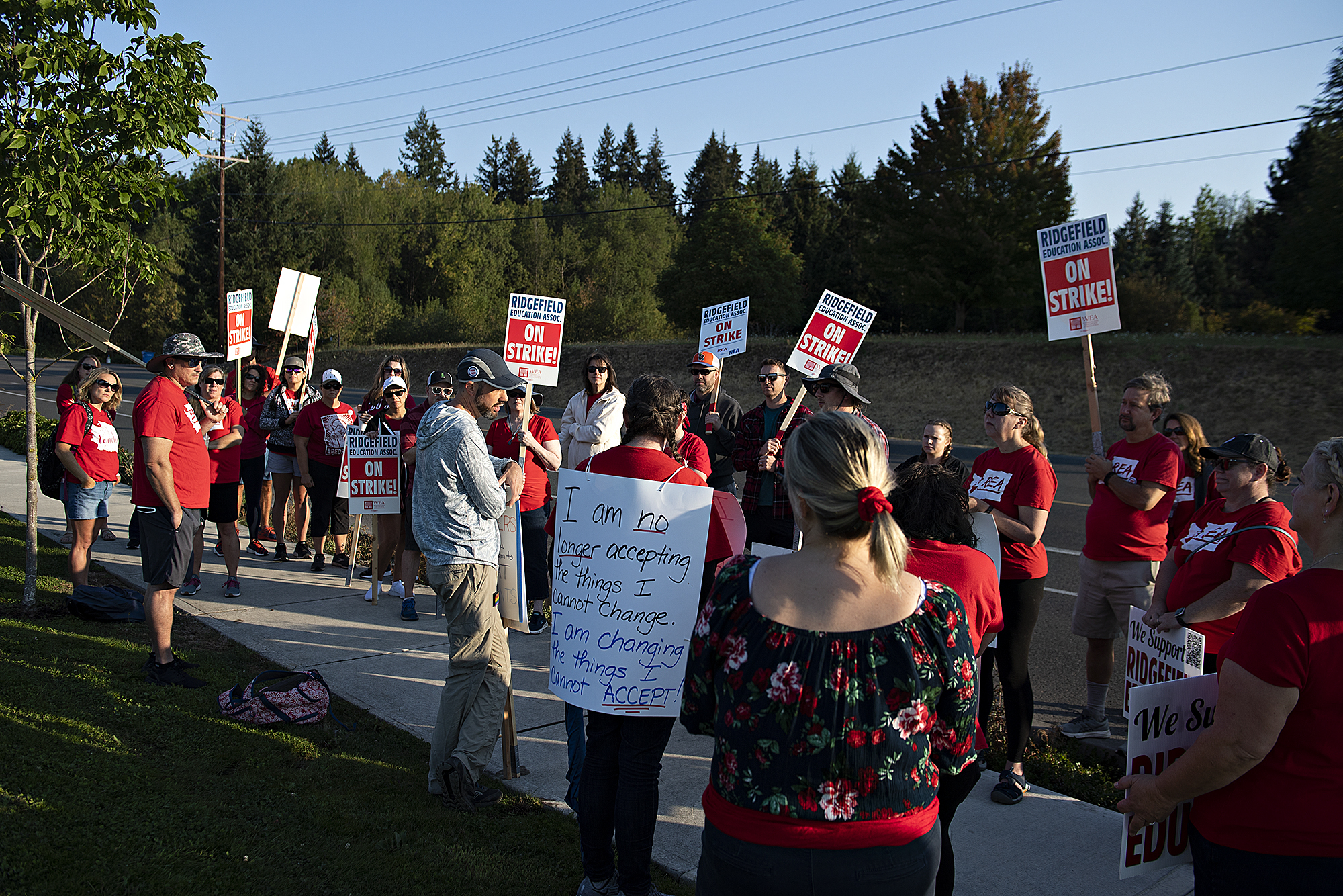 Joe Thayer, center in gray sweatshirt and hat, joins union members as they gather to strike after a deal has not been reached between the teachers union and school officials despite working without a contract since Sep. 1, as seen in Ridgefield on Friday morning, Sept. 9, 2022.