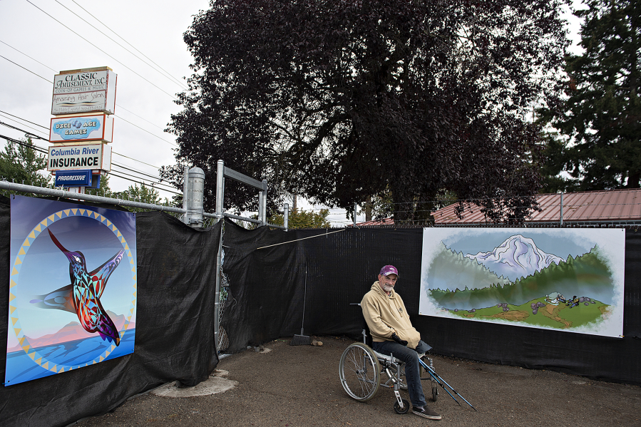 Hope Village resident Jimmy John Howland sits by his favorite mural at Hope Village, the city's second Safe Stay Community. The mountainous landscape featured in the mural reminds him of Trillium Lake, where he used to go with his dad when he was younger.