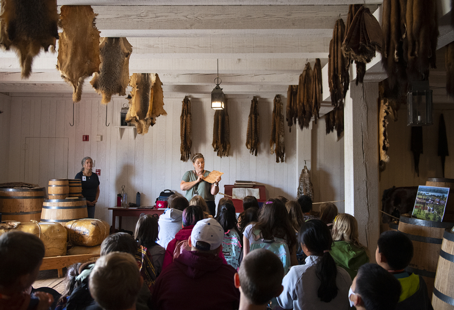 Jen Flores, center, who teaches at the Vancouver Innovation, Technology and Arts Elementary School, talks with students as they visit the fur store at Fort Vancouver National Historic Site on Tuesday morning. The curriculum was designed for the partnership between Vancouver Public Schools and the National Park Service. Students at VITA Elementary School will come and learn for two weeks at a time on a rotating basis.