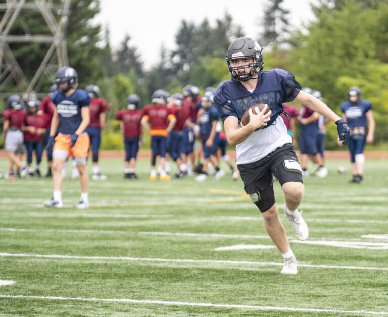 King's Way senior Aidan Sweeney runs the ball Tuesday, Sept. 13, 2022, during practice at King's Way Christian High School. The football team is 2-0 in its second year back competing at a varsity level.