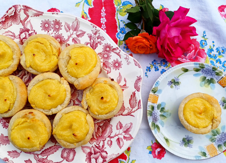 Authentic Portuguese Tarts are made with a sugar syrup and thickened with flour. These tarts rely on cornstarch and a bit of custard powder, plus six egg yolks.