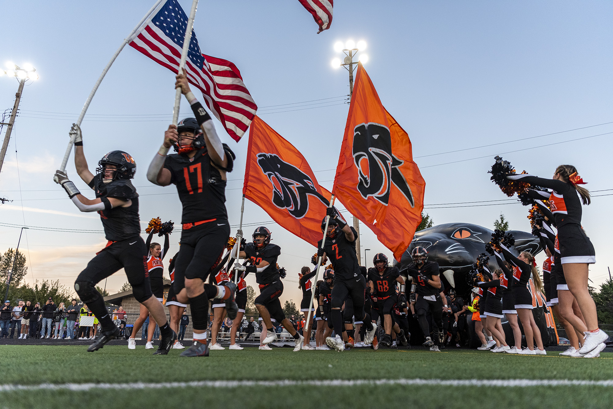 Washougal’s football team storms onto the field Friday, Sept. 23, 2022, before the Panthers’ 39-22 win against Mark Morris at Washougal High School.