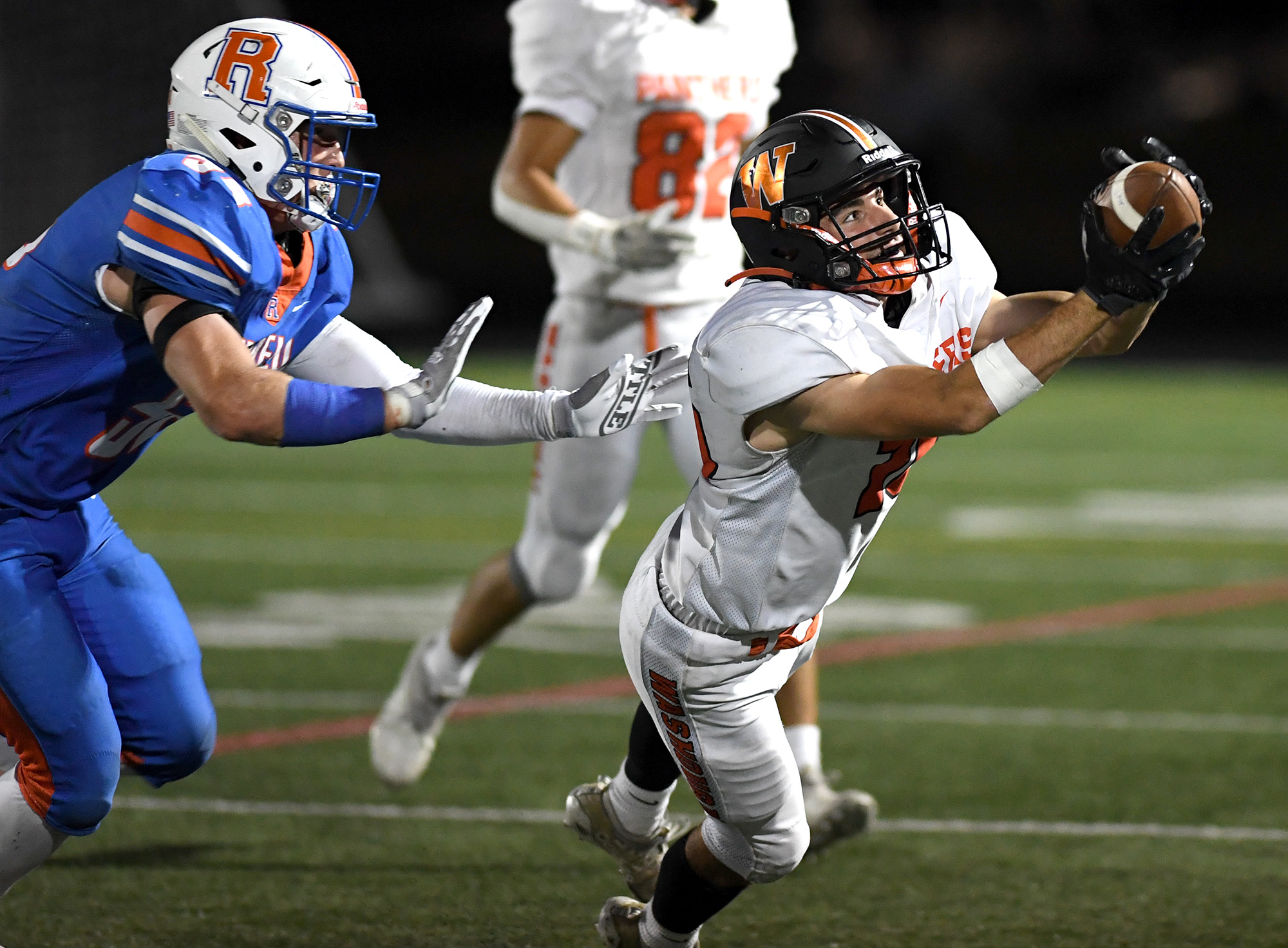 Washougal senior Talon Connelly, right, makes a diving reception Friday, Sept. 30, 2022, during a game between Washougal and Ridgefield at Ridgefield High School.