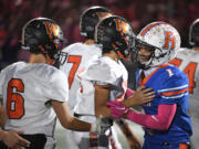 Ridgefield senior Isaiah Cowley, right, congratulates Washougal players on a good game Friday, Sept. 30, 2022, after the Spudders’ 34-27 loss to Washougal at Ridgefield High School.