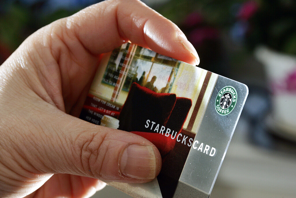 A person holds a Starbucks Coffee card Wednesday, Nov. 31, 2007, in  Pennington, N.J.