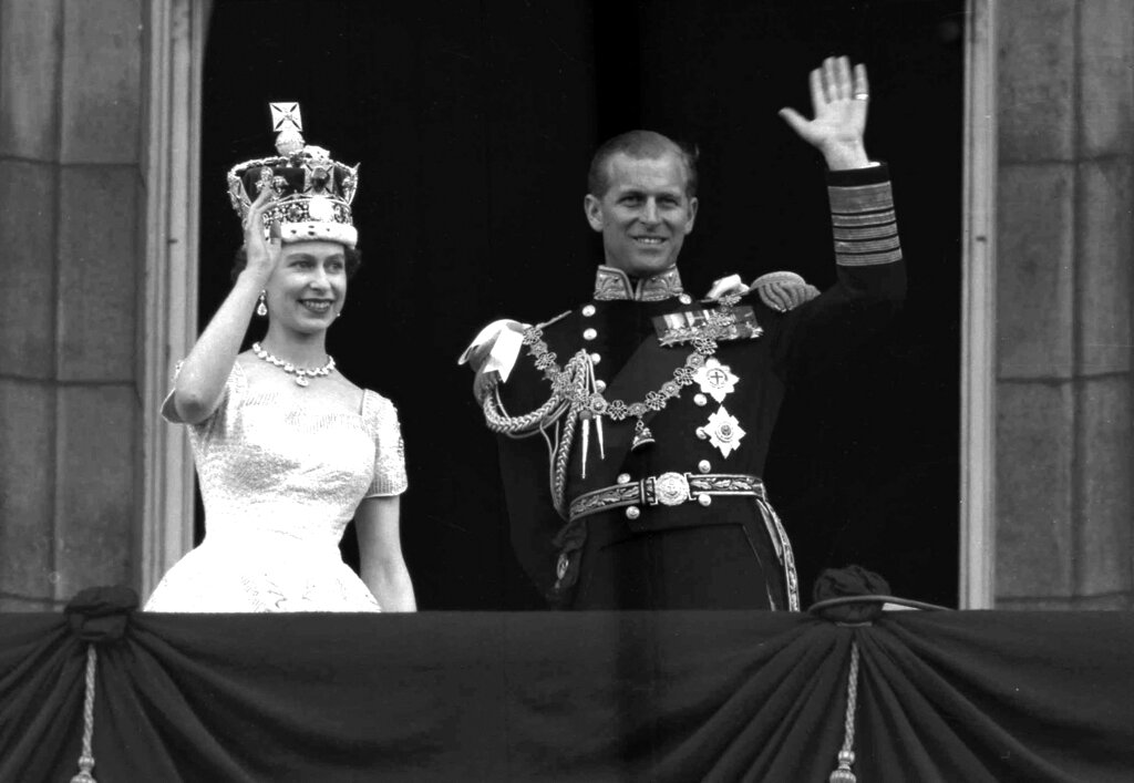 FILE - In this June. 2, 1953 file photo, Britain's Queen Elizabeth II and Prince Philip, Duke of Edinburgh wave to supporters from the balcony at Buckingham Palace, following her coronation at Westminster Abbey, London. Queen Elizabeth II, Britain’s longest-reigning monarch and a rock of stability across much of a turbulent century, has died. She was 96. Buckingham Palace made the announcement in a statement on Thursday Sept. 8, 2022.