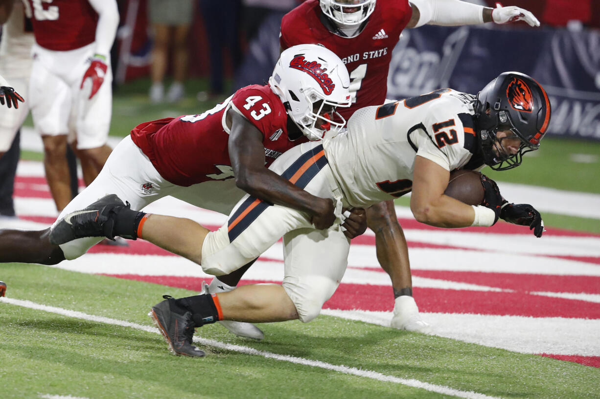 Oregon State linebacker and running back Jack Colletto heads in to the end zone for the game winning score as Fresno State defensive back Morice Norris tries to stop him during the second half of an NCAA college football game in Fresno, Calif., Saturday, Sept. 10, 2022.
