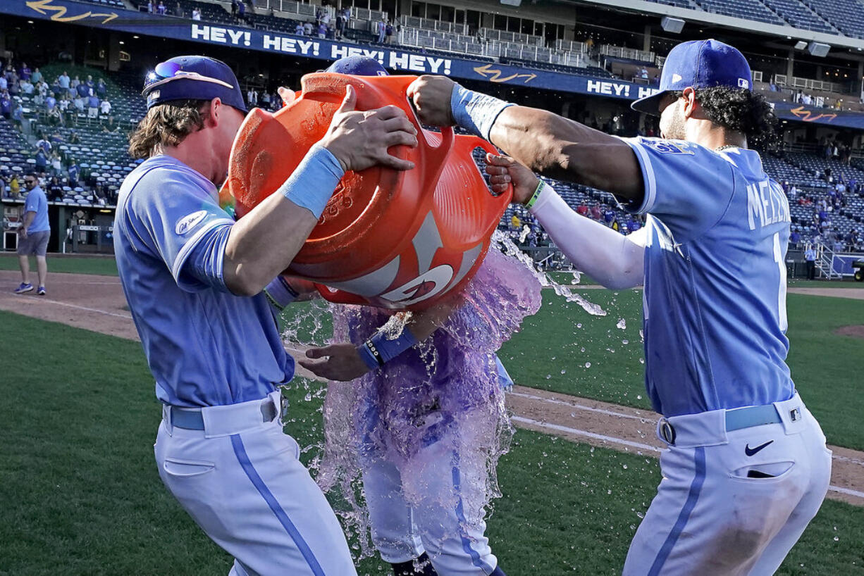 Kansas City Royals' Michael Massey is doused by Bobby Witt Jr., left, and MJ Melendez (1) after their baseball game against the Seattle Mariners Sunday, Sept. 25, 2022, in Kansas City, Mo. The Royals won 13-12.
