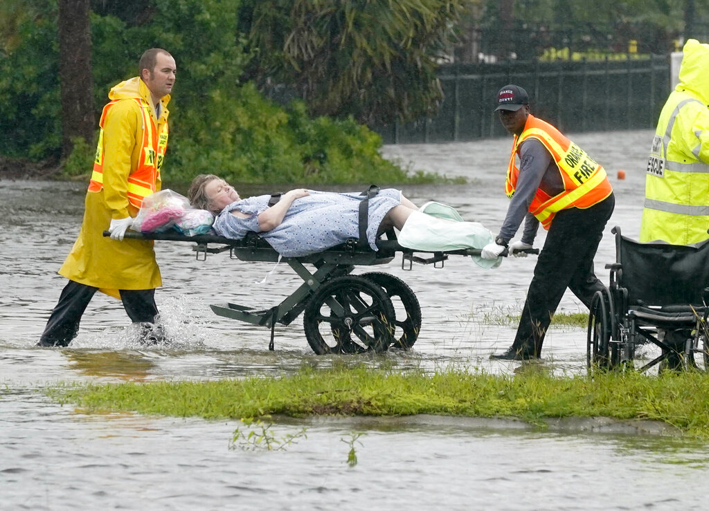 Authorities transport a person out of the Avante nursing home in the aftermath of Hurricane Ian, Thursday, Sept. 29, 2022, in Orlando, Fla. Hurricane Ian carved a path of destruction across Florida, trapping people in flooded homes, cutting off the only bridge to a barrier island, destroying a historic waterfront pier and knocking out power to 2.5 million people as it dumped rain over a huge area on Thursday.
