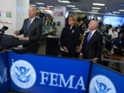 President Joe Biden speaks about Hurricane Ian during a visit to FEMA headquarters, Thursday, Sept. 29, 2022, in Washington. FEMA Administrator Deanne Criswell and Homeland Security Secretary Alejandro Mayorkas look on.