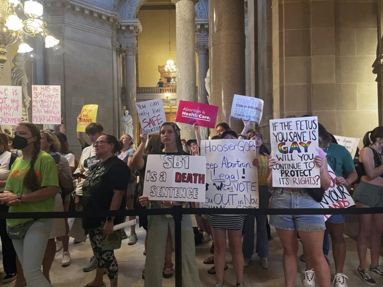 FILE - Abortion-rights protesters fill Indiana Statehouse corridors and cheer outside legislative chambers, Friday, Aug. 5, 2022, as lawmakers vote to concur on a near-total abortion ban, in Indianapolis. An Indiana judge on Thursday, Sept.