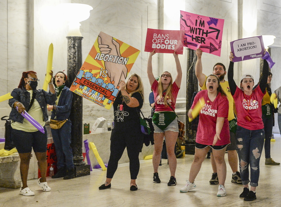Abortion rights supporters demonstrate outside the Senate chamber at the West Virginia state Capitol on Tuesday, Sept. 13, 2022, in Charleston, W.Va., as lawmakers debated a sweeping bill to ban abortion in the state with few exceptions.