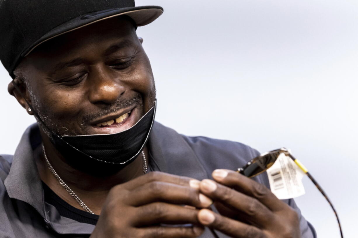 Harold Lewis, a recovering drug user, looks at a pair of sunglasses he won by picking paper slips with prizes written on them out of a fishbowl July 18 at Liberation Programs in Bridgeport, Conn. "Recovery is just not all balled-up fists and clutched teeth, you know what I mean?" Lewis says.
