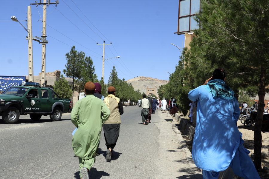 Afghan people run near the site of an explosion in Herat province, Afghanistan, Friday, Sept 2, 2022. Taliban officials and a local medic say an explosion tore through a crowded mosque in western Afghanistan, killing more than a dozen of people, including a prominent cleric.
