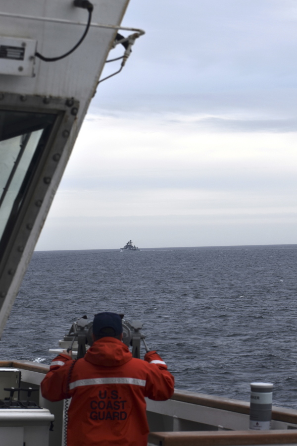 In this photo provided by the U.S. Coast Guard, a Coast Guard Cutter Kimball crew-member observes a foreign vessel in the Bering Sea, Monday, Sept. 19, 2022. The U.S. Coast Guard cutter on routine patrol in the Bering Sea came across the guided missile cruiser from the People's Republic of China, officials said Monday, Sept. 26.  (U.S.
