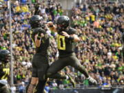 Oregon quarterback Bo Nix (10) celebrates a touchdown against BYU with Oregon tight end Terrance Ferguson during the first half of an NCAA college football game, Saturday, Sept. 17, 2022, in Eugene, Ore.