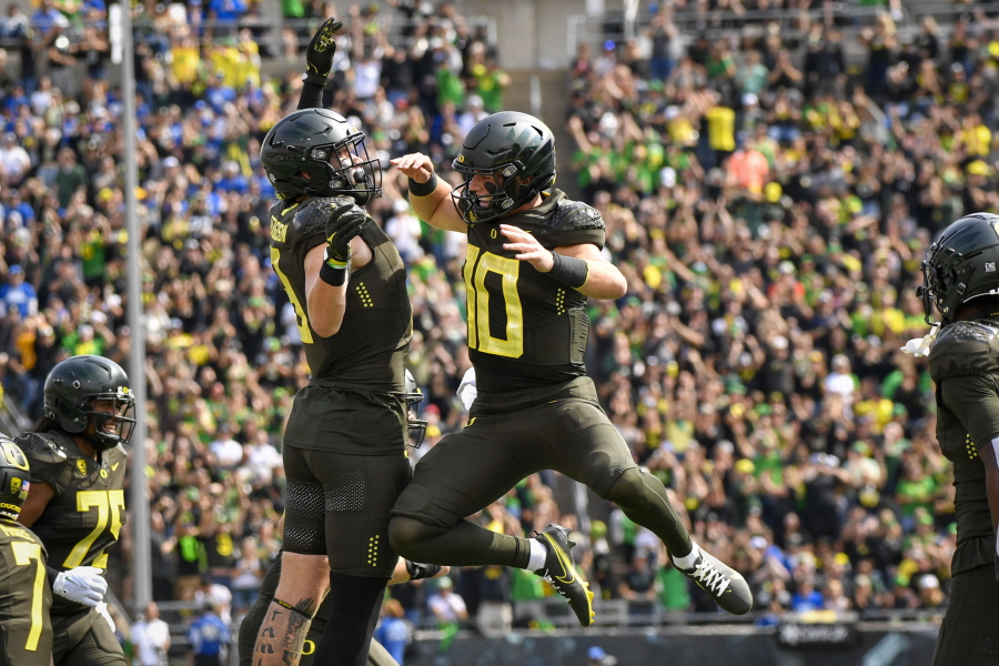 Oregon quarterback Bo Nix (10) celebrates a touchdown against BYU with Oregon tight end Terrance Ferguson during the first half of an NCAA college football game, Saturday, Sept. 17, 2022, in Eugene, Ore.