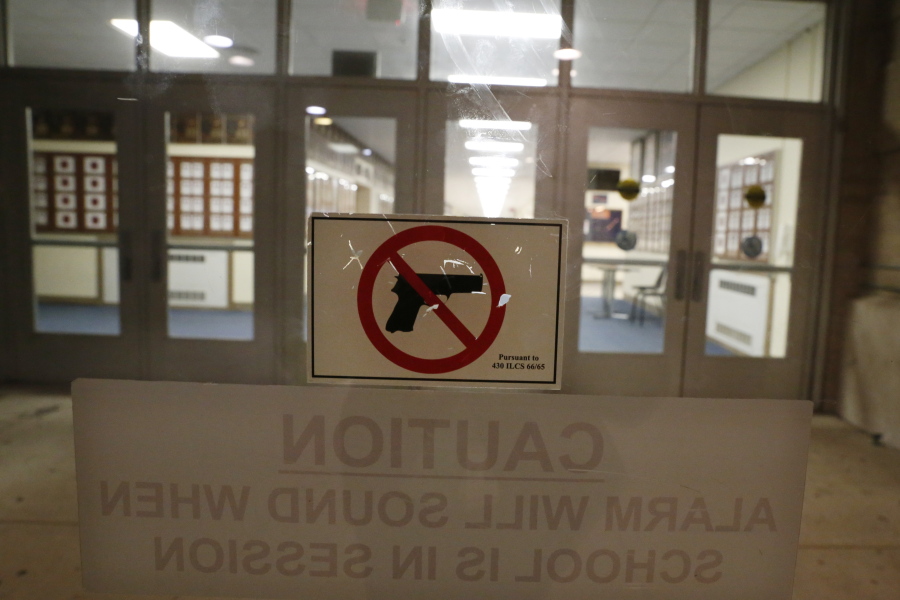 A no-gun sticker is displayed a doorway at Oak Park and River Forest High School on Thursday, Aug. 25, 2022, in Oak Park, Ill. Despite laws banning guns from schools, educators in cities, suburbs and rural areas say keeping guns out of schools is difficult.