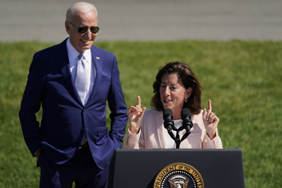 President Joe Biden looks on as Secretary of Commerce Gina Raimondo speaks before the President signs the "CHIPS and Science Act of 2022" during a ceremony on the South Lawn of the White House, Tuesday, Aug. 9, 2022, in Washington.