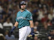 Seattle Mariners' Cal Raleigh returns to the dugout after striking out against the Atlanta Braves during the ninth inning of a baseball game Friday, Sept. 9, 2022, in Seattle.