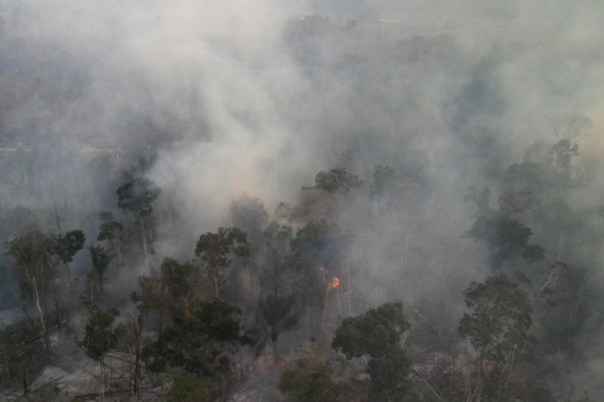 FILE - Smoke rises from forest fires in the region of Novo Progresso, in Par?, Brazil, on Aug. 21, 2022. More fires burned in the Brazilian Amazon rainforest this August than in any month in nearly five years, thanks to a surge in illegal deforestation.